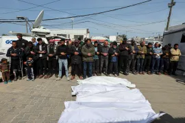 Mourners pray next to the bodies of Palestinians killed in Israeli strikes, at Al-Aqsa Martyrs hospital, in Deir el-Balah in the central Gaza Strip, March 25, 2025. [Ramadan Abed/Reuters]
