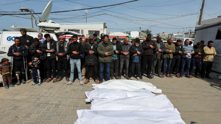 Mourners pray next to the bodies of Palestinians killed in Israeli strikes, at Al-Aqsa Martyrs hospital, in Deir el-Balah in the central Gaza Strip, March 25, 2025. [Ramadan Abed/Reuters]