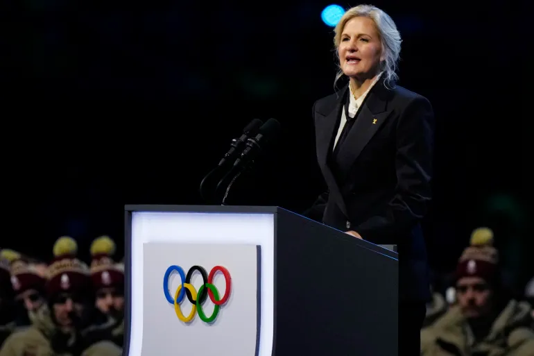 President Kirsty Coventry speaks at a stadium.