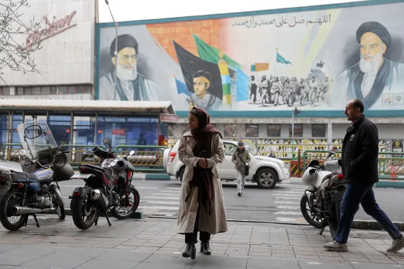 People walk next to a mural with a picture of Iran's Supreme Leader, Ayatollah Ali Khamenei, on a street in Tehran, Iran, February 7, 2026. Majid Asgaripour/WANA (West Asia News Agency)