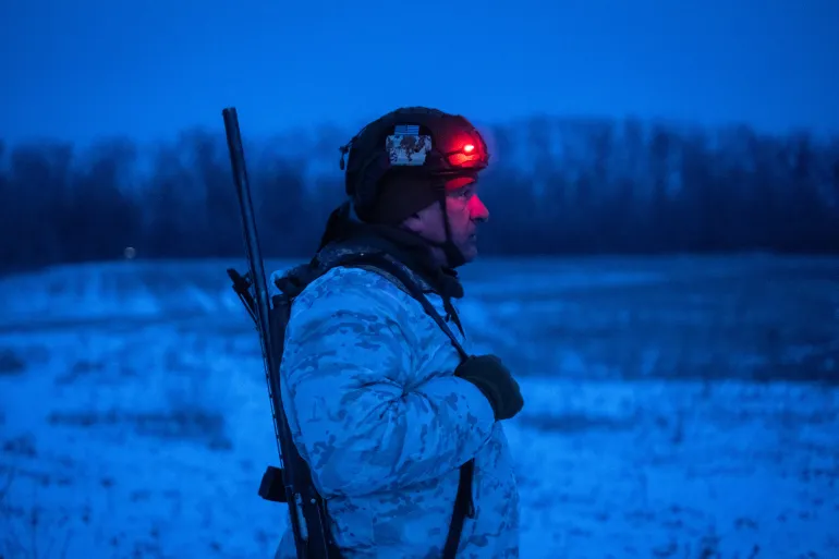A Ukrainian soldier stands in a field at an undisclosed location near Druzhkivka, Donetsk region, amid the Russian invasion of Ukraine. [AIryna Rybakova /AFP]