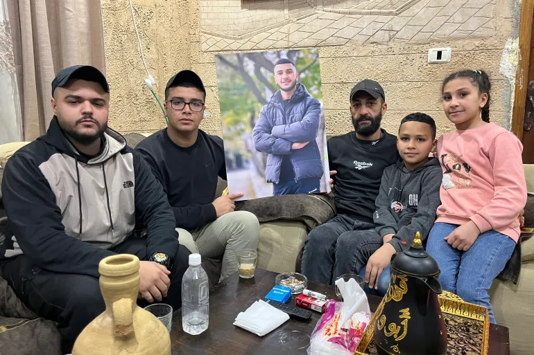 People gathered around a large picture