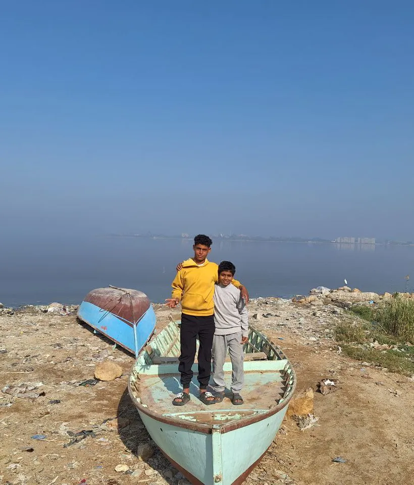 Children stand on boat left on dry land