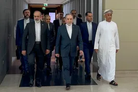 In this handout photo obtained from Iran’s foreign ministry delegation on February 6, 2026, Iran’s Foreign Minister Abbas Araghchi (C) arrives for a meeting in Muscat.