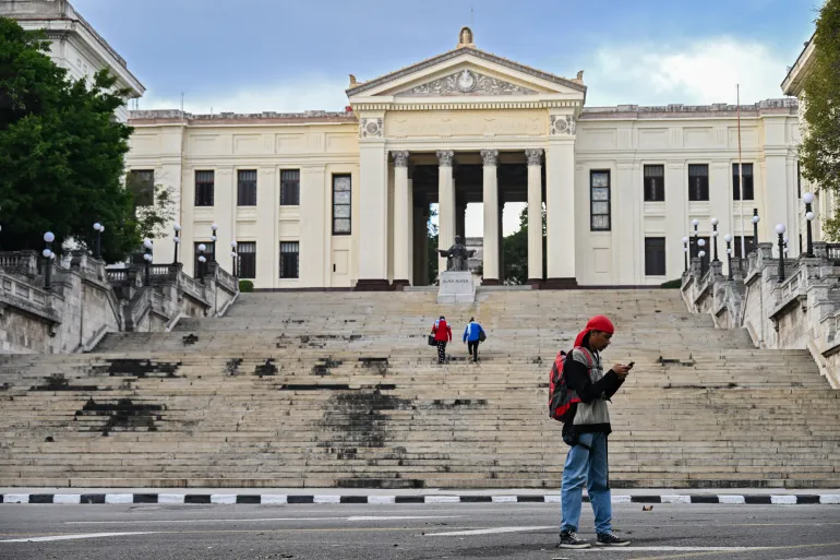 A young man uses his mobile phone in front of the University of Havana on February 6, 2026.